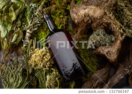 Vintage bottles with tinctures and various dried herbs. 132788197