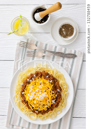 Cincinnati chili with spaghetti on white plate 132788459