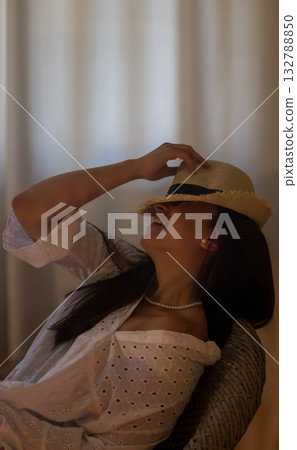 Young hispanic woman laughing joyfully wearing straw hat 132788850