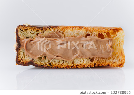 Close-up of chocolate-filled croissant slice with creamy texture and golden layers 132788995