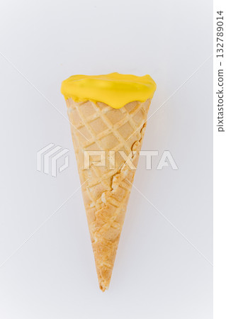 Yellow ice cream cone isolated on white background, bright minimal summer dessert concept Yellow ice cream cone isolated on white background, bright minimal summer dessert concept 132789014