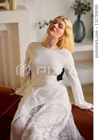Elegant indoor fashion scene, Stylish woman in cozy modern Elegant indoor fashion scene, Stylish woman in cozy modern 132789099