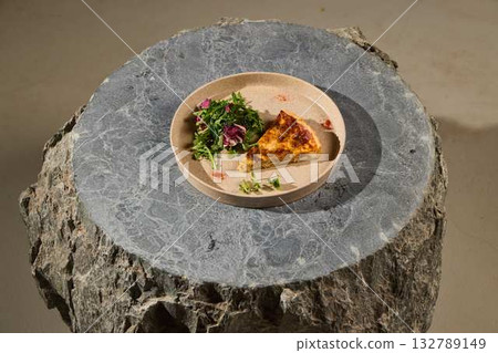 A Mouthwatering and Delicious Slice of Frittata Served on a Beautiful Stone Table 132789149