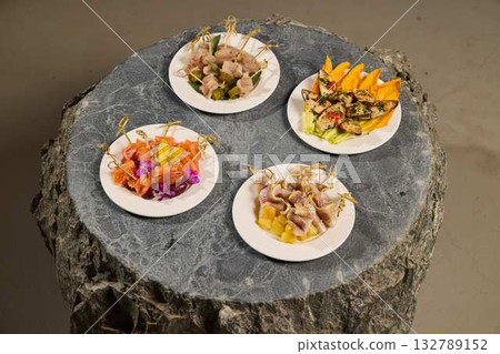 A Gourmet Platter Featuring A Variety Of Colorful Dishes Artfully Presented On A Natural Stone Base 132789152