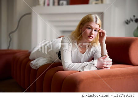 Contemplative woman relaxing, Elegant lady seated thoughtfully Contemplative woman relaxing, Elegant lady seated thoughtfully 132789185