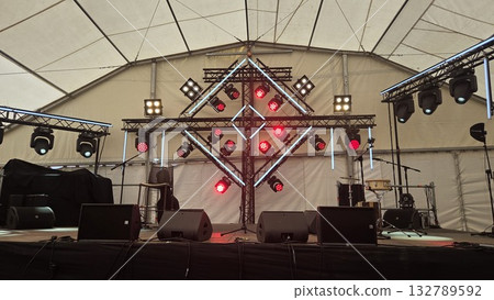 Concert stage setup with light equipment in event tent for live performance Concert stage setup with light equipment in event tent for live performance 132789592