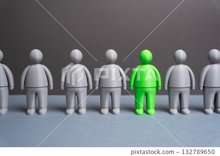 A green man among grays. A talented person. The best of the candidates. Individuality, creativity, and leadership potential. Recruitment, personal growth, and recognition of unique skills. 132789650