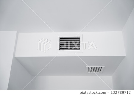 White air duct and vent grille integrated into modern minimalist wall design White air duct and vent grille integrated into modern minimalist wall design 132789712