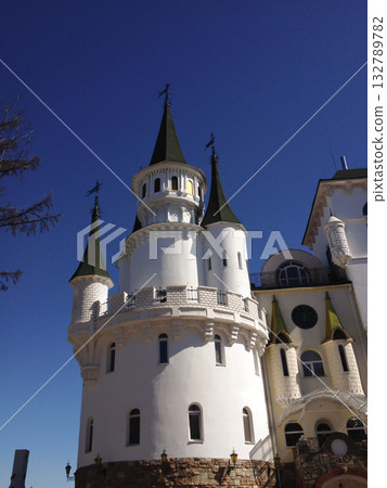 White fairytale castle under deep blue sky. Architecture, heritage, imagination and childhood fascination with fantasy structures. 132789782