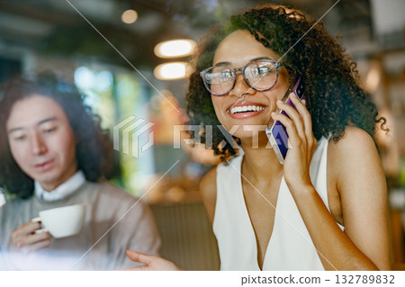 casual cafe interaction, authentic snapshot of remote work life with cheerful coworkers in hip casual cafe interaction, authentic snapshot of remote work life with cheerful coworkers in hip 132789832