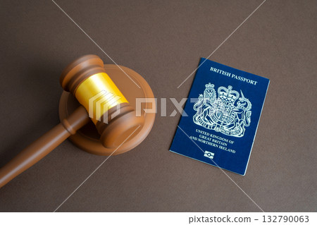 British passport and judge's gavel. Court and protection of the rights of citizens of Great Britain. Citizenship and right of residence. Brexit policy, visa regulation, and migration law enforcement. 132790063