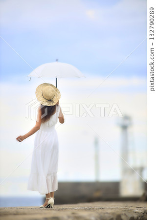 A woman walking in a seaside town A woman walking in a seaside town 132790289