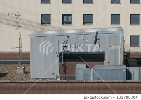 Antennas installed on the roof of a residential building. Concept of communication. 132790304