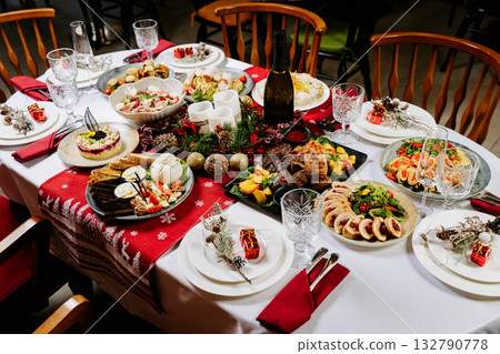 Festive Christmas dinner table with traditional holiday dishes and elegant table setting 132790778