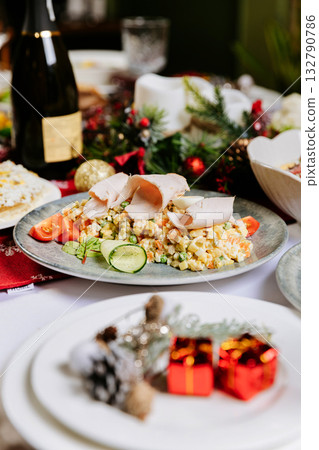 Traditional Olivier salad with turkey and vegetables on festive Christmas table Traditional Olivier salad with turkey and vegetables on festive Christmas table 132790786