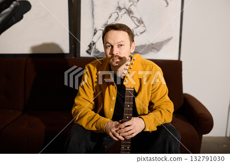 Intimate scene of guitarist showcasing thoughtful mood for album 132791030