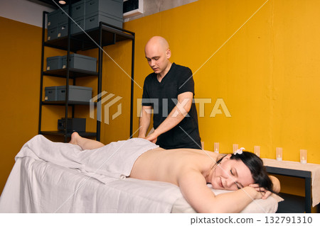 Indulging in a Relaxing Massage Therapy Session at a Modern Wellness Studio for Ultimate Relaxation 132791310