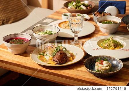 Experience exquisite Japanese cuisine beautifully served on a traditional wooden table Experience exquisite Japanese cuisine beautifully served on a traditional wooden table 132791346