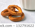 Three salted pretzels with poppy seeds on a stone gray table. 132791622