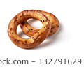 Two salted pretzels with poppy seeds isolated on a white background. 132791629