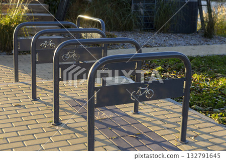 Empty bicycle parking lot in a city park. 132791645