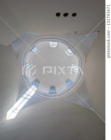 White dome inside the church with a sun spot White dome inside the church with a sun spot 132791671