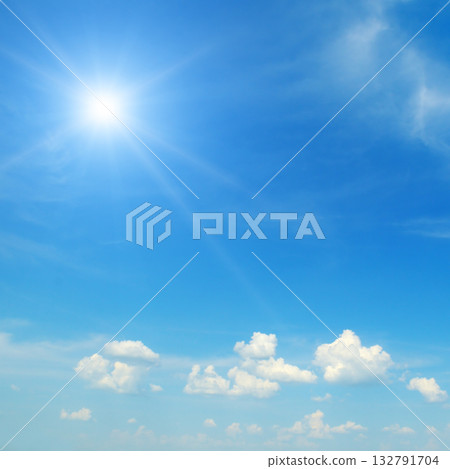 Bright Sunburst in Clear Blue Sky with Few White Clouds Bright Sunburst in Clear Blue Sky with Few White Clouds 132791704