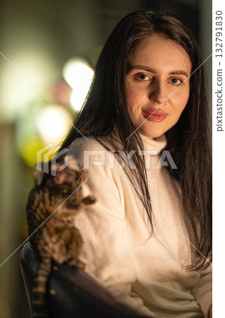 girl smiles while seated with her marmoset on her shoulder in a warm softly lit indoor space. The atmosphere feels relaxed and joyful capturing a special moment between them. girl smiles while seated with her marmoset on her shoulder in a warm softly lit indoor space. The atmosphere feels relaxed and joyful capturing a special moment between them. 132791830