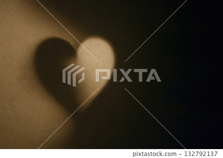 A heart-shaped shadow on the wall is a symbol of love. Space for text. 132792137