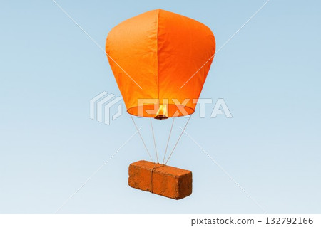 A brick is suspended from a balloon. 132792166