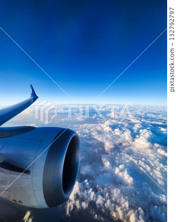 Airplane Wing and Engine above Clouds 132792797