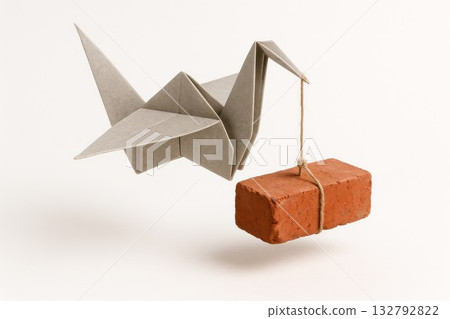 Origami crane carrying a brick on a rope. 132792822