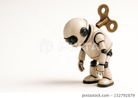 A tired clockwork robot on a light background. Space for text. 132792879