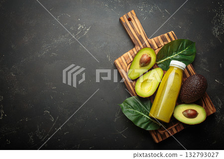 Avocado smoothie fresh fruit halves dark background cutting board healthy drink diet nutrition copy space Avocado smoothie fresh fruit halves dark background cutting board healthy drink diet nutrition copy space 132793027