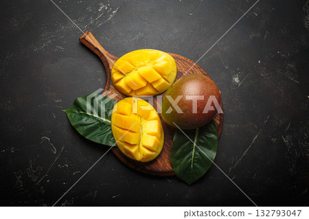 Fresh mango exotic fruit sliced whole cutting board dark background preparing 132793047