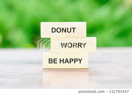 Wooden blocks stacked together display the fun phrase about joy and positivity, encouraging a lighthearted approach to life while surrounded by lush greenery and bright sunlight Wooden blocks stacked together display the fun phrase about joy and positivity, encouraging a lighthearted approach to life while surrounded by lush greenery and bright sunlight 132793437