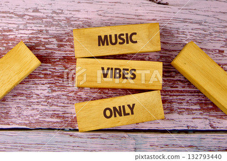 Wooden blocks with the words MUSIC VIBES ONLY are arranged creatively on a textured wooden surface. The scene evokes feelings of creativity and relaxation Wooden blocks with the words MUSIC VIBES ONLY are arranged creatively on a textured wooden surface. The scene evokes feelings of creativity and relaxation 132793440