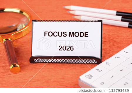 A message reads Focus Mode 2026 next to tools for planning. A magnifying glass, calculator, and pencils hint at diligent preparation for the future 132793489