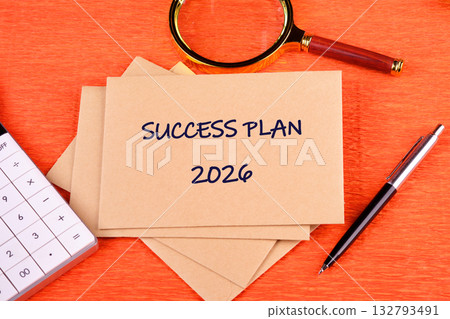 The 2026 Success Plan unfolds with a pen, a magnifying glass, and calculator nearby, hinting at calculations and reviews, all set against a textured orange backdrop The 2026 Success Plan unfolds with a pen, a magnifying glass, and calculator nearby, hinting at calculations and reviews, all set against a textured orange backdrop 132793491