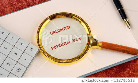 A magnifying glass with the words UNLIMITED POTENTIAL 2026 is focused on a white paper, accompanied by a pen and calculator, on a patterned surface A magnifying glass with the words UNLIMITED POTENTIAL 2026 is focused on a white paper, accompanied by a pen and calculator, on a patterned surface 132793538