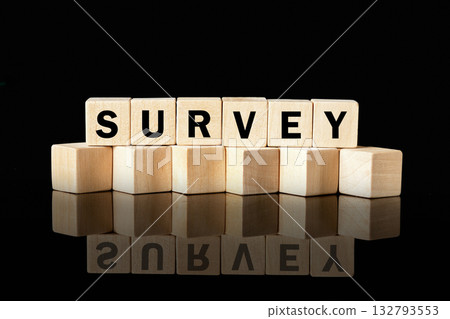 Wood blocks spell out the word SURVEY against a black background. The blocks reflect on the surface below, highlighting the importance of data collection and analysis Wood blocks spell out the word SURVEY against a black background. The blocks reflect on the surface below, highlighting the importance of data collection and analysis 132793553