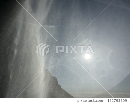 This is a view of the waterfall at the basin of Seljalandsfoss, a waterfall in southern Iceland, with the sunset shining beyond. This is a view of the waterfall at the basin of Seljalandsfoss, a waterfall in southern Iceland, with the sunset shining beyond. 132793809