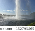 This is a view of the waterfall and the violent spray from behind the pool of Seljalandsfoss, a waterfall in southern Iceland. 132793865