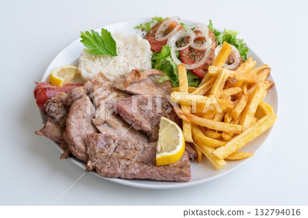 Savored beef with crispy sides, Juicy grilled meat served with rice and crunchy potato fries, Savory beef slices alongside fluffy rice and crispy fried potatoes on plate Savored beef with crispy sides, Juicy grilled meat served with rice and crunchy potato fries, Savory beef slices alongside fluffy rice and crispy fried potatoes on plate 132794016