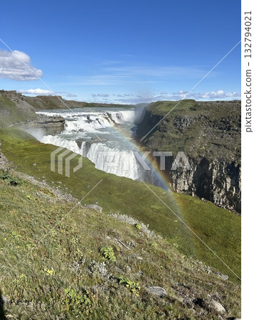 Gullfoss, the Golden Waterfall, is a waterfall in southern Iceland, with a beautiful rainbow miraculously appearing in the foreground. Gullfoss, the Golden Waterfall, is a waterfall in southern Iceland, with a beautiful rainbow miraculously appearing in the foreground. 132794021