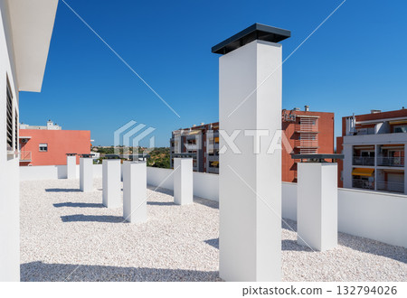 Bright roofscape imagery, Sunny top with structures, Illuminated rooftop featuring architecture details, Sunshine bathes flat roof with distinctive features and shadows Bright roofscape imagery, Sunny top with structures, Illuminated rooftop featuring architecture details, Sunshine bathes flat roof with distinctive features and shadows 132794026