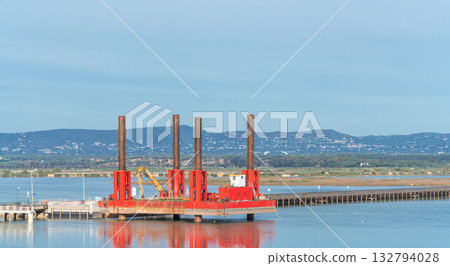 Faro, Portugal, bridge, Waterfront construction with engineers, Bridge assembly on water with project team, Seaside construction operation involving engineers 132794028