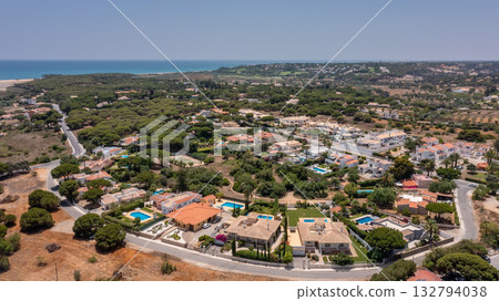 Aerial, Quarteira, Portugal Seaside community with vibrant colors, Coastal landscape featuring lively warm color palette, Beautiful shoreline view showcasing charming 132794038