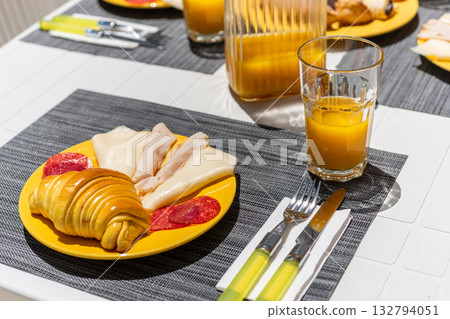 Colorful morning meal presentation, Bright and inviting breakfast table setting scene, Cheerful and appealing continental breakfast setup for hospitality display Colorful morning meal presentation, Bright and inviting breakfast table setting scene, Cheerful and appealing continental breakfast setup for hospitality display 132794051