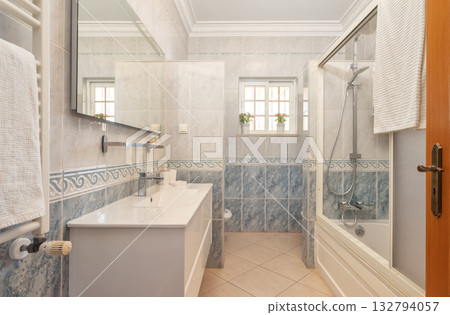 Refined shower area decorated in gentle colors with useful accessories, Luxurious bathroom environment emphasizing calm palette and essential fixtures for comfort Refined shower area decorated in gentle colors with useful accessories, Luxurious bathroom environment emphasizing calm palette and essential fixtures for comfort 132794057